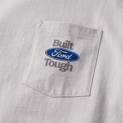 Close-up of a white pocket tee featuring a chest pocket with 'Built Ford Tough' embroidered in gray and the blue oval Ford logo.