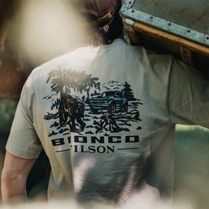 Person wearing a t-shirt with a graphic design and 'Bionco Filson' text.