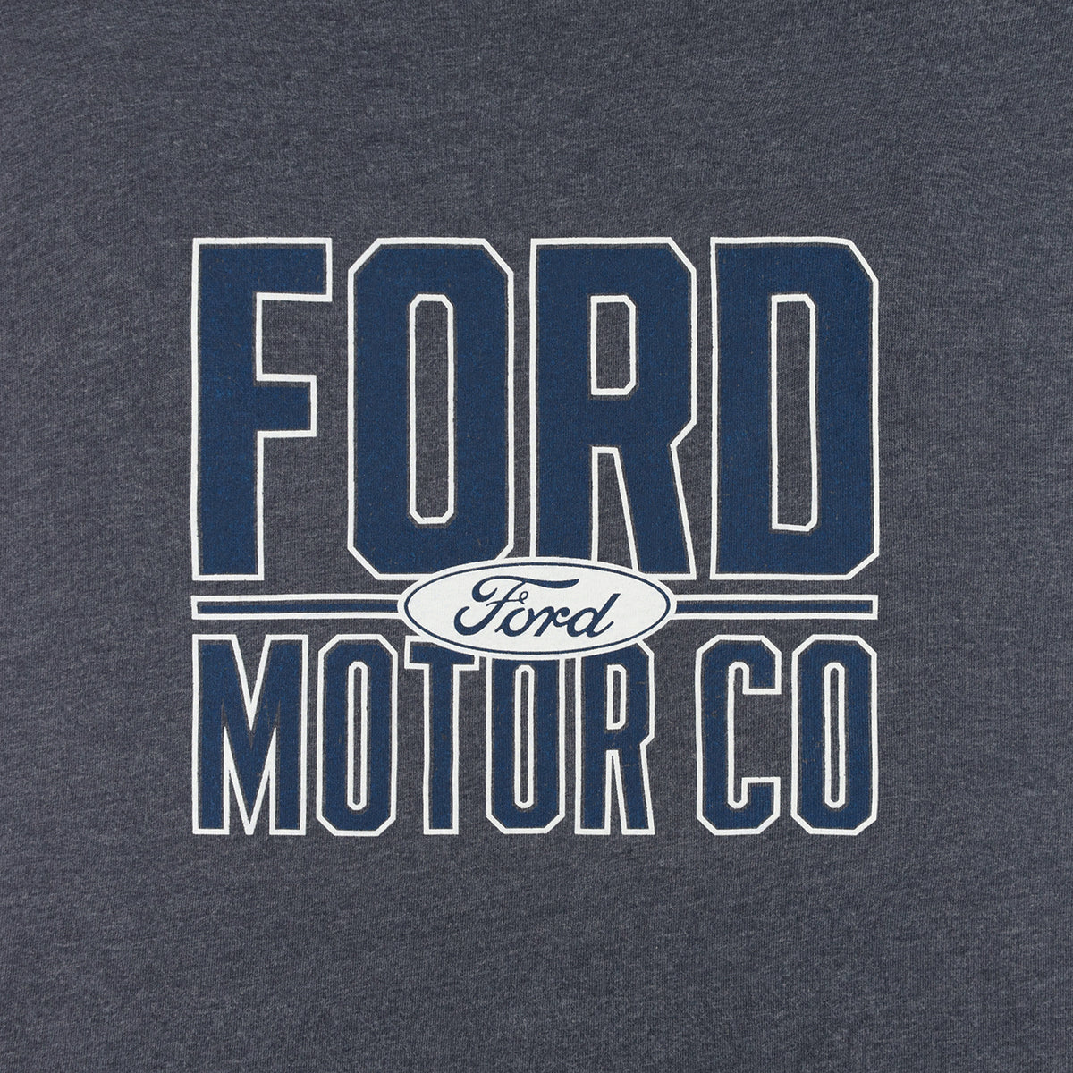 A close-up of a dark heather gray t-shirt featuring a navy blue and white collegiate-style graphic that reads 'FORD MOTOR CO' with the oval Ford logo in the center.