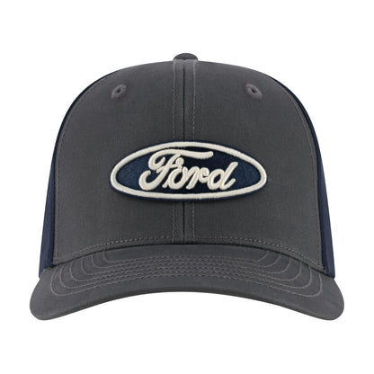 A dark gray Ford trucker-style cap with navy blue mesh side panels and a prominent embroidered oval Ford logo patch on the front, set against a plain white background.