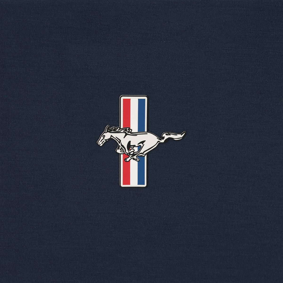 close up of a Ford Mustang tribar pony logo on a navy blue background