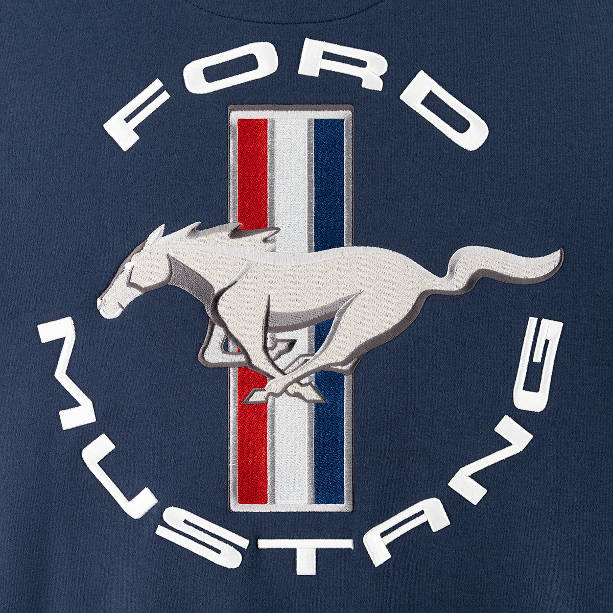 close up of a Ford Mustang tribar pony logo graphic on a navy blue background