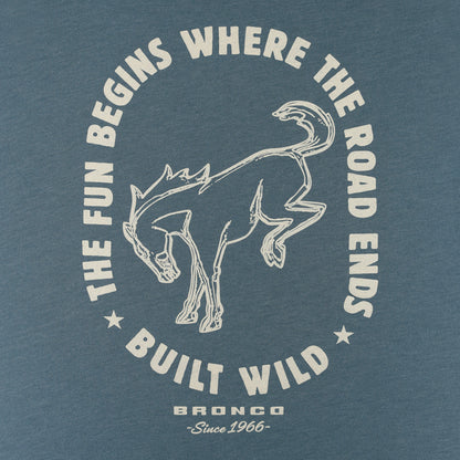 A close-up of a blue-gray heathered t-shirt featuring a vintage-style graphic print. The design displays a white line-art illustration of a bronco surrounded by the text 'THE FUN BEGINS WHERE THE ROAD ENDS' and 'BUILT WILD', with 'BRONCO Since 1966' printed below.