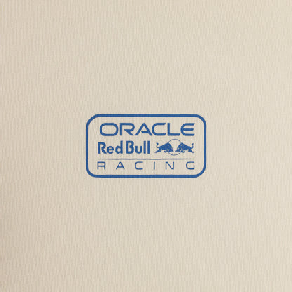 A close-up of a cream-colored fabric surface featuring a blue printed Oracle Red Bull Racing logo.