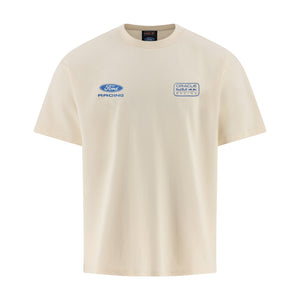 A cream-colored short-sleeve t-shirt featuring a blue Ford Racing logo on the left chest and a circular Track of the Americas Racing logo on the right chest, displayed on a clean white background.