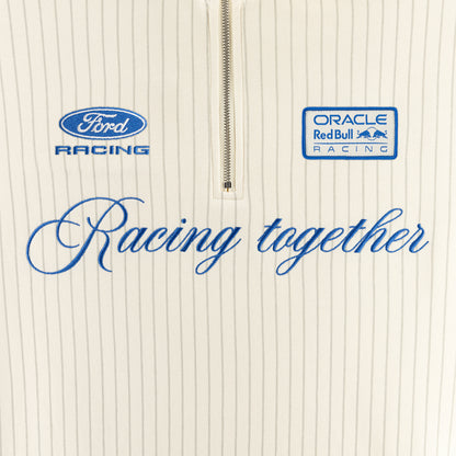 Close-up of a cream pinstriped zip-up garment with blue Ford Racing and Oracle Red Bull Racing logos and the phrase 'Racing together' across the front.