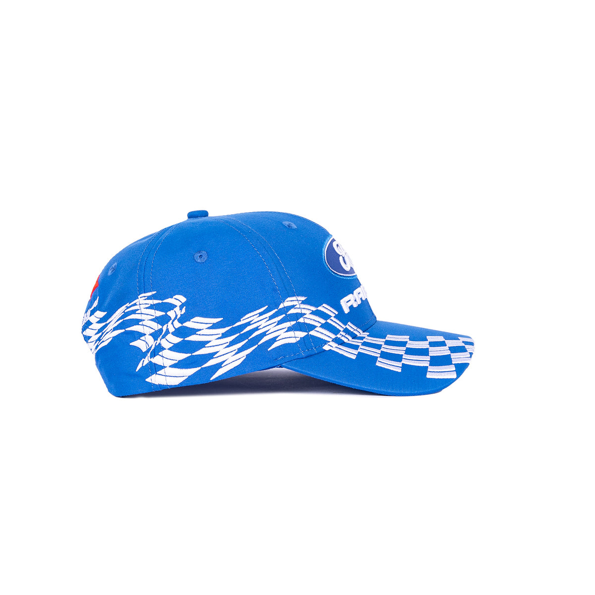 A blue baseball cap shown from the side, featuring a white checkered pattern on the brim and a white graphic design across the side panels, with a circular logo patch on the front.