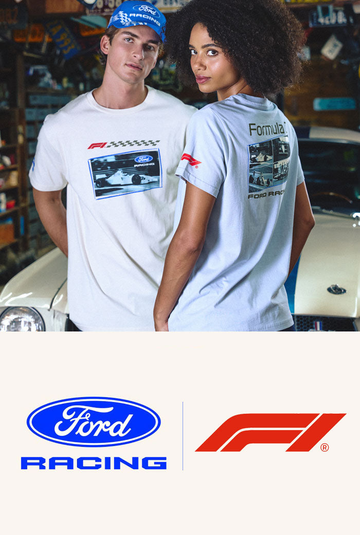 ford racing x formula 1 logos and man and women wearing formula 1 apparel standing in a garage