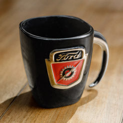 Black ford mug with Ford logo emblem on a wooden surface