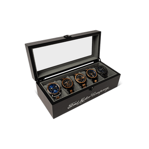 Set of five watches in a branded wooden display box on a black background