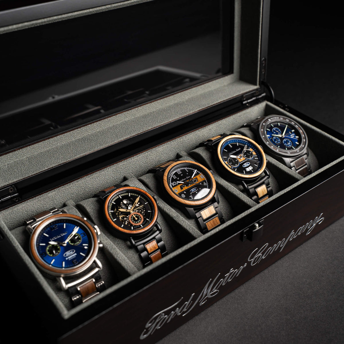Set of six Ford Motor Company watches in a display case.