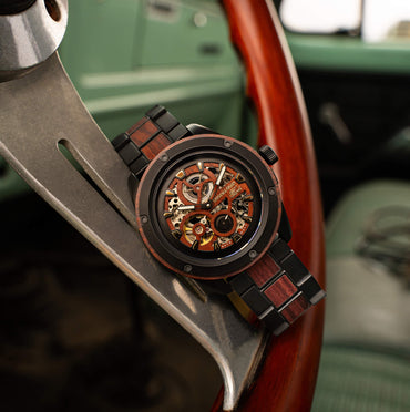 Wooden watch with mechanical components on a car dashboard