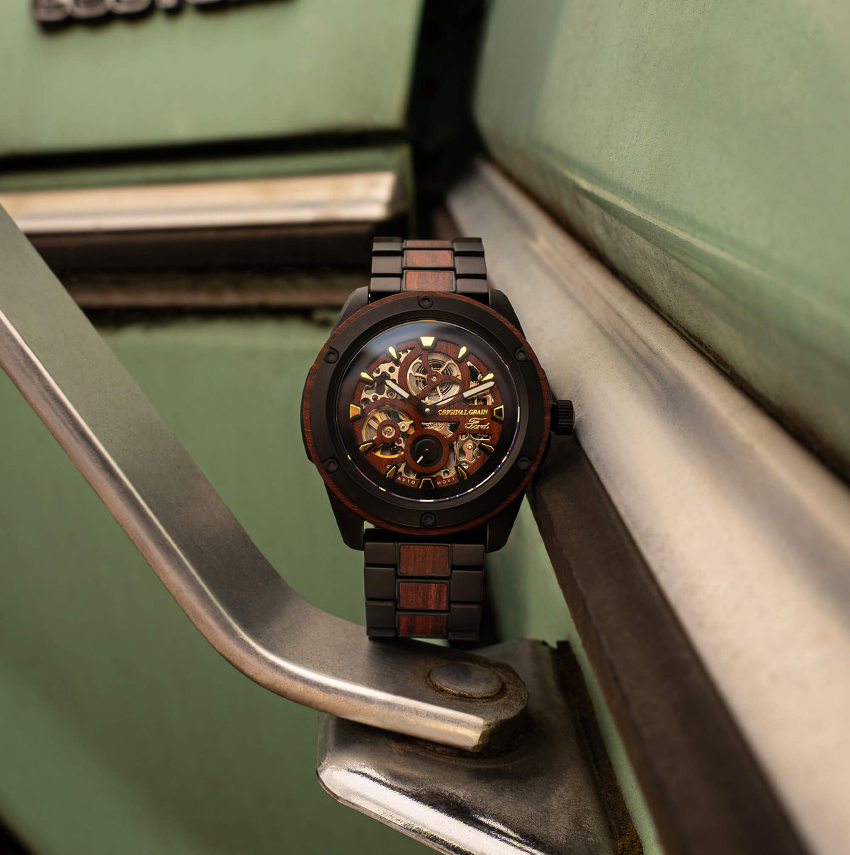 Watch with a detailed face and wooden strap on a metallic surface