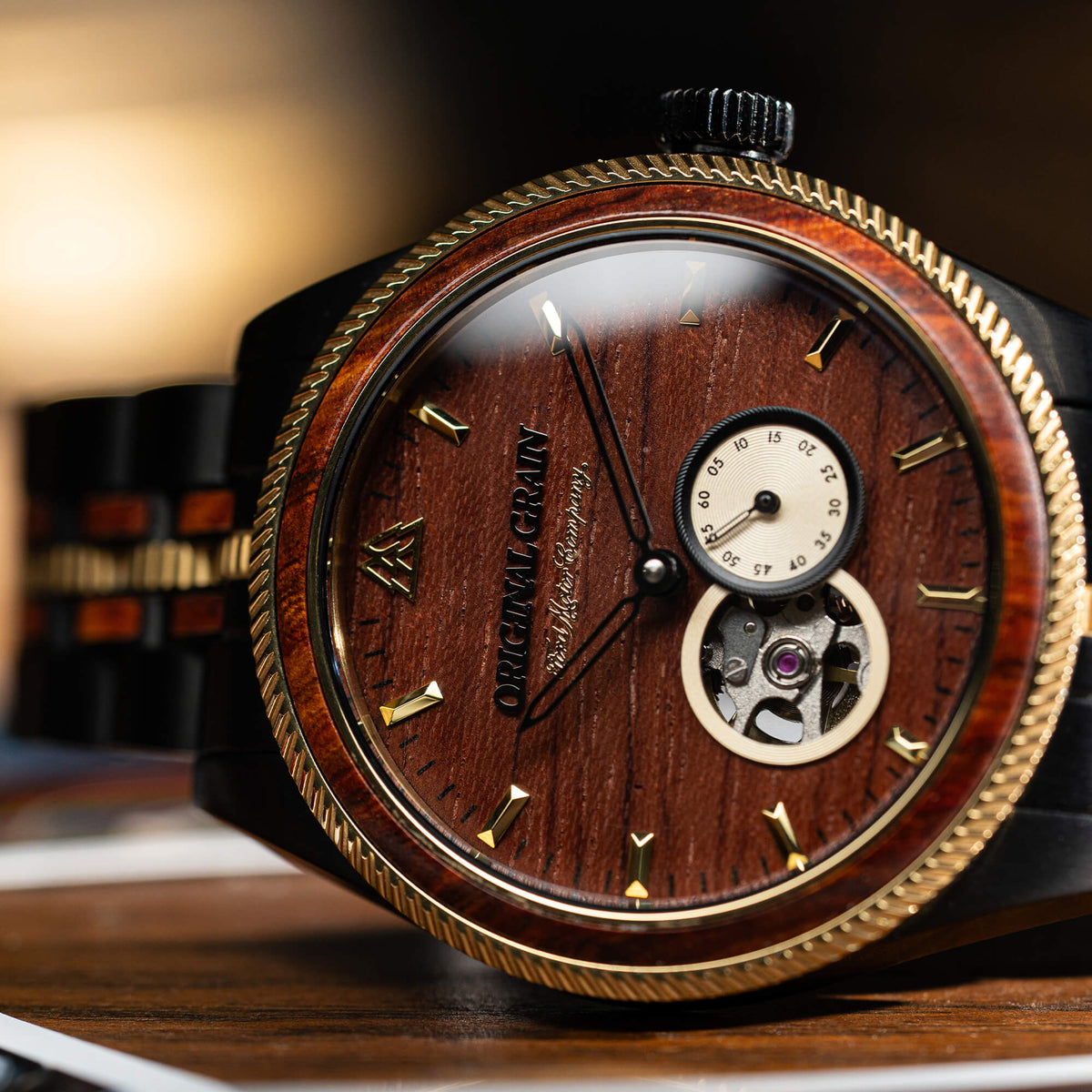 Wooden watch with gold accents on a wooden surface