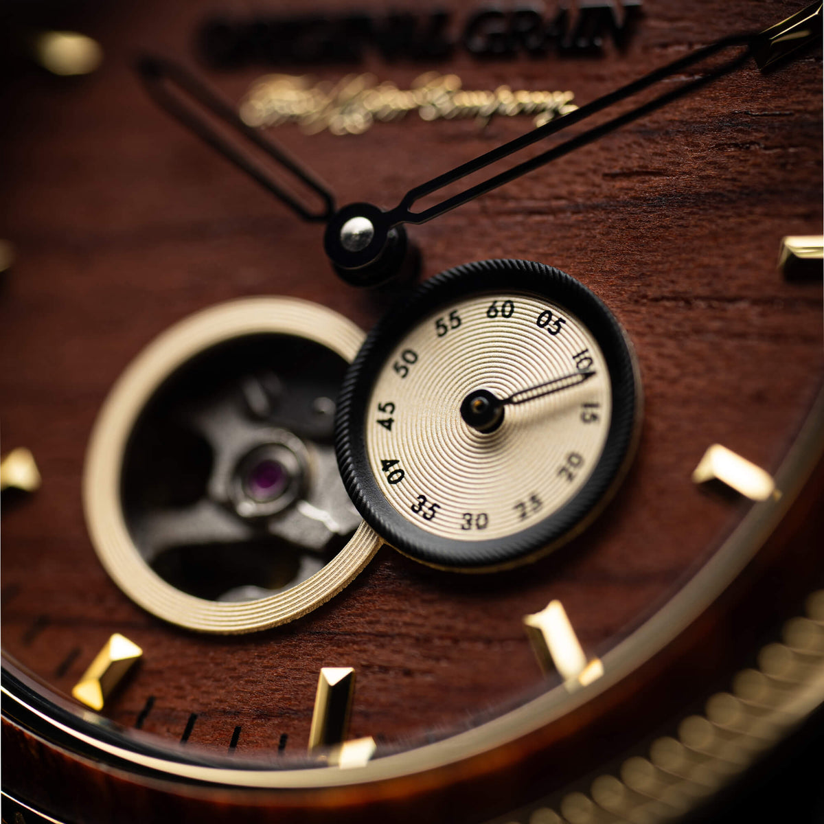 Close-up of a watch with visible brand name on wooden background